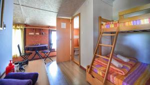 a room with two bunk beds and a table at San Art Floating Hostel & Apartments in Belgrade