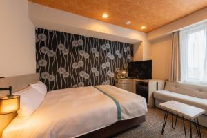 Postel nebo postele na pokoji v ubytování Tosei Hotel Cocone Asakusa