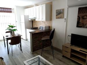 una cocina con una mesa pequeña y una cocina con encimera en Apartaloft LA CELESTINA, en Almagro