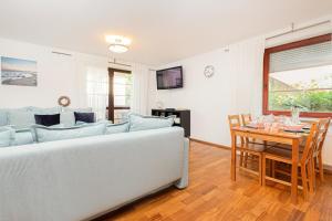 a living room with a couch and a table at Apartments Tarifa - by the sea by Renters in Sopot