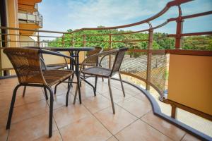 a balcony with two chairs and a table on a balcony at Apartamenty na Wyspie - Zdrojowa in Świnoujście +70 photos