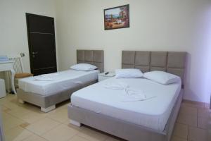 Voodi või voodid majutusasutuse Hotel Rixhi toas