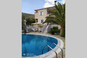 a villa with a swimming pool and a house at Luxury Villa with swimming pool in Aliveri