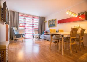 a living room with a table and chairs and a couch at Apartamenty na Wyspie - Zdrojowa in Świnoujście