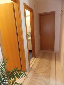 a hallway with a door leading to a bathroom at Apartments and Rooms Jasna in Hvar