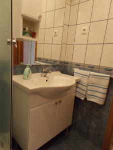 a bathroom with a sink and a mirror at Apartments and Rooms Jasna in Hvar