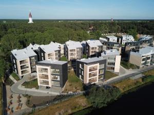 an aerial view of a cluster of apartment buildings with a lighthouse at Lighthouse Apartment Šventosios Vartai in Palanga