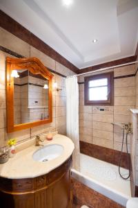 a bathroom with a sink and a tub and a mirror at Luxury Rustic Villa Mountain View in Lefkada Town +37 photos