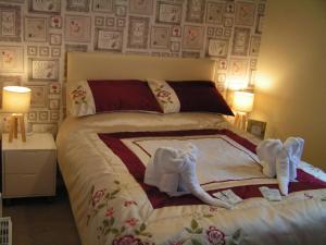 a bedroom with a bed with towels on it at Devon Guest House in Blackpool