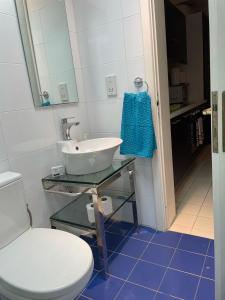 a bathroom with a white toilet and a sink at Angolina Apartments 130 in Birżebbuġa