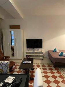 a living room with a flat screen tv on the wall at Angolina Apartments in Birżebbuġa