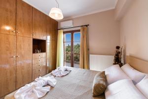 a bedroom with a large bed and a window at Luxury Rustic Villa Mountain View in Lefkada Town