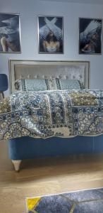 a bed with a quilt on it in a bedroom at Skyline by Nights & Smiles in Tuzla