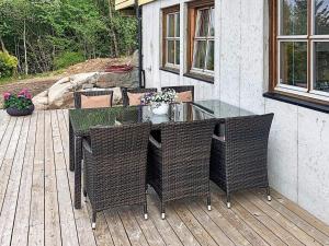 a patio with a table and chairs on a deck at 6 person holiday home in Tau in Tau