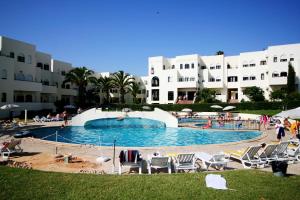 a large swimming pool in front of a building at Villas2go2 Studio Alvor in Alvor