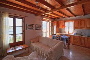 a living room with a couch and a table at Sonia's Apartment in Fiscardo Waterfront in Fiskardho