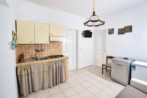 a kitchen with a sink and a stove top oven at SoleMarePonza Casa Maria in Ponza