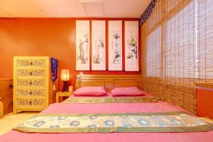 a bedroom with two beds with pink pillows at B&B under Great Wall in Huairou