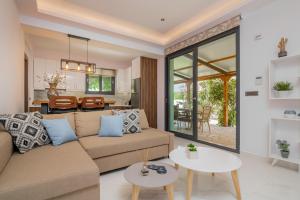 a living room with a couch and a table at Allegra Villa in Kipseli