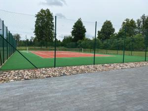 a tennis court with a chain link fence at Lättemaa in Raanitsa