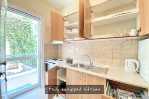 a kitchen with a sink and a window at Afitos Beach Apartments in Afitos