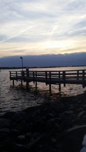 a wooden pier in the water with a light on it at Ferienwohnung-Suedstrandflair in Burgtiefe auf Fehmarn 