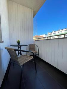 a balcony with two chairs and a table and a window at 02 Gdynia Centrum - Apartament Mieszkanie dla 2 os in Gdynia