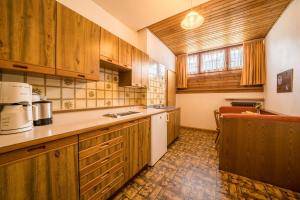 a kitchen with wooden cabinets and a counter top at Apartment Gantkofel Leilichhof in Lana