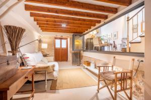 a living room with a couch and a table and chairs at Ca Sa Mar in Sóller