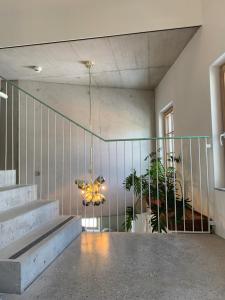 a lobby with stairs and a chandelier in a building at pradl elf my- apartment in Innsbruck