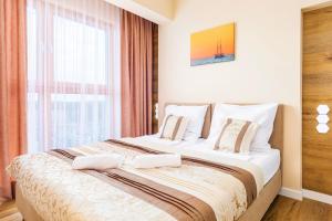 Posteľ alebo postele v izbe v ubytovaní Platan Tower Baltic & More Apartments