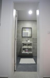 a bathroom with a white sink and a mirror at Code Srebrno Jezero in Veliko Gradište