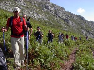 un grupo de personas caminando por un sendero de montaña en Casa de la Montaña Albergue Turístico en Avín