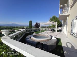 a hot tub on the balcony of a house at Relais Villa Belvedere & SPA ONLY ADULTS in Pozzolengo