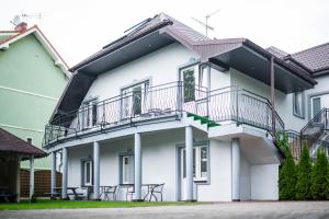 a white building with balconies on the side of it at Donata in Rewal