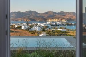 a view from a window of a city with mountains at Milos Breeze Boutique Hotel in Pollonia