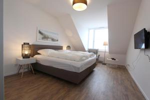Una cama o camas en una habitación de Kellenhus Whg 10 OG