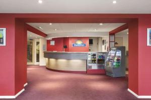 a store with a drink counter and a soda machine at Ramada London South Mimms in Potters Bar