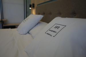 a white pillow with a picture of a person on it at Hostal Real Maqueda in Málaga