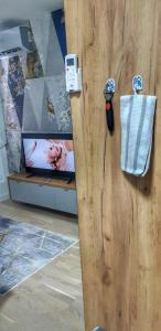 an open wooden door with a picture of a baby at Identity By Nights & Smiles in Tuzla +88 photos