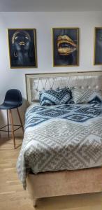 ein Schlafzimmer mit einem Bett mit zwei Bildern an der Wand in der Unterkunft Identity By Nights & Smiles in Tuzla