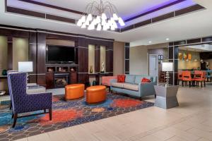 a living room with a couch and a fireplace at Comfort Inn & Suites in Cleveland
