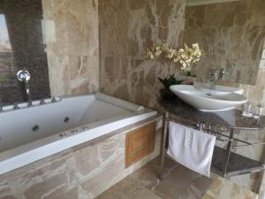 a bathroom with a bath tub and a sink at Westbury Residence in Pattaya South +27 photos