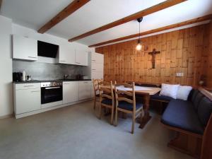 a kitchen and dining room with a table and chairs at Ferienhaus Sarah in Schruns