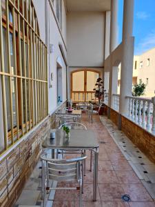 a row of tables and chairs on a balcony at Hostal Las Dunas in El Cabo de Gata