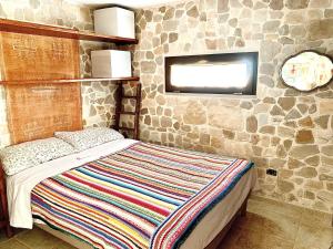 Postel nebo postele na pokoji v ubytování Antica casa Maria degli Ulivi