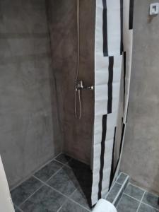 a shower with a black and white shower curtain at Double M near Athens Airport in Markopoulo