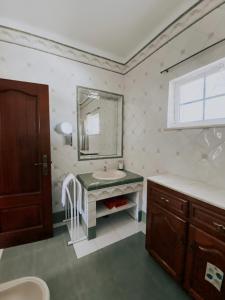 a bathroom with a sink and a mirror at São Cristóvão Farmhouse Setúbal in Setúbal