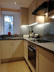 a kitchen with a sink and a stove top oven at Pitlochry North Wing Apartment, very central in Pitlochry
