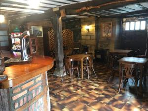 a bar with wooden tables and chairs in a restaurant at La ermita 1826 in Rudaguera